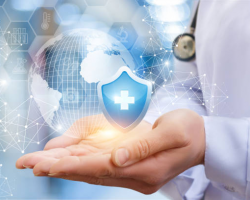 Hand holding a digital shield with a medical cross symbolizing healthcare protection.